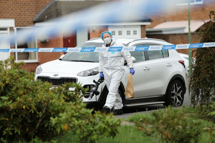 A police forensic officer outside a property on Northdown Road in Solihull.