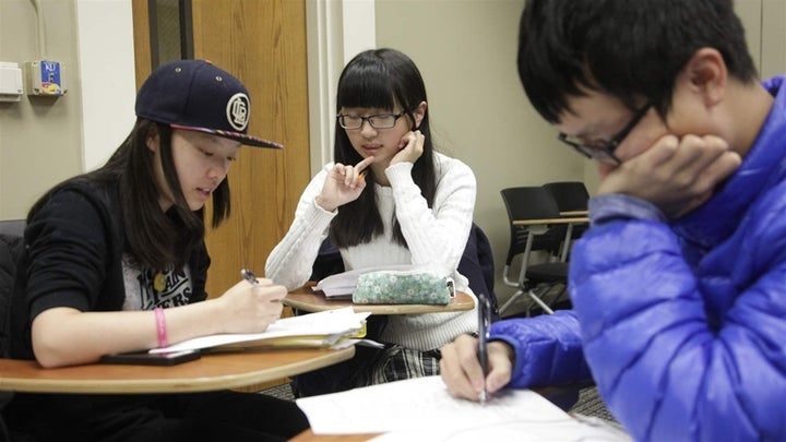 <p>Three students from China participate in a Kansas University environment and culture class. Universities have stepped up efforts to recruit international students, in part to increase tuition revenue.</p>