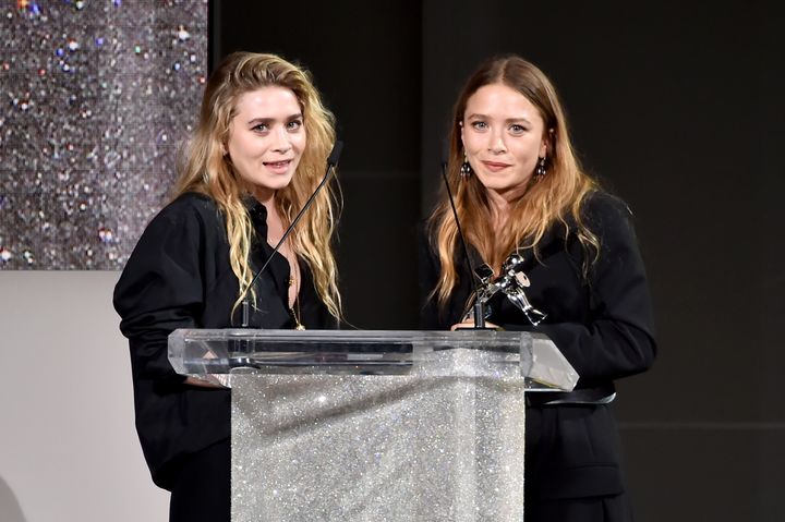 Ashley and Mary-Kate Olsen accept an award from the Council of Fashion Designers of America in 2018.