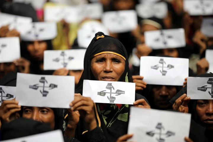 Rohingya refugee women hold placards as they take part in a protest at the Kutupalong refugee camp.