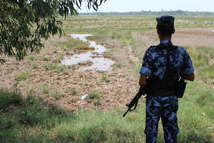 A Myanmar border guard stands guard near the Taung Pyo Letwe reception camp overlooking the border with Bangladesh, in the Rakhine state.