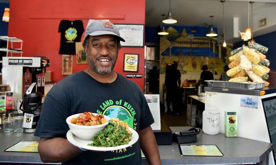 Gregory Brown holds a plate from his restaurant in Baltimore on Aug. 26, 2016. 