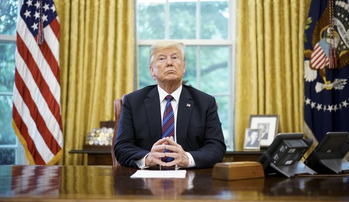 President Donald Trump speaks on the phone with Mexico's President Enrique Pena Nieto on trade in the Oval Office of the White House in Washington, DC on August 27, 2018.