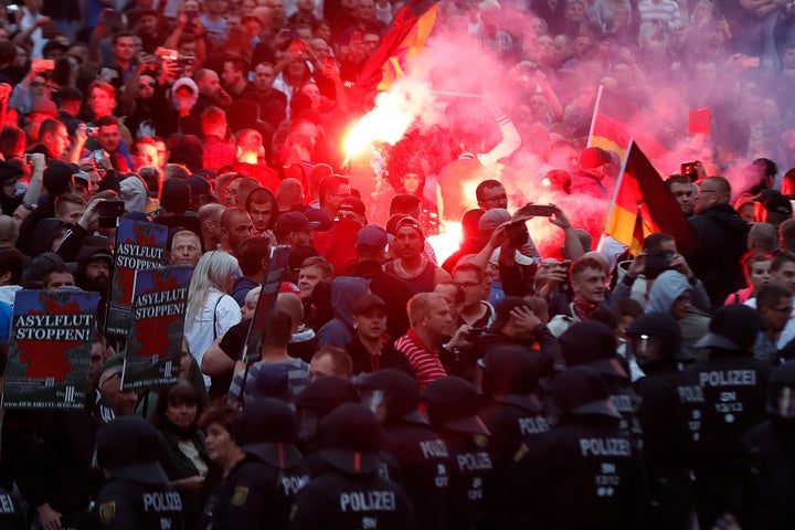 Right-wing demonstrators light flares on Aug. 27 in Chemnitz, Germany, following the death of a 35-year-old German national who died in hospital after a "dispute between several people of different nationalities," according to the police.