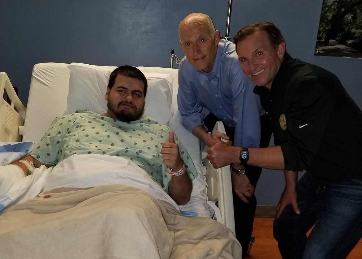 Timothy “oLARRY” Anselimo poses with Florida Gov. Rick Scott from his hospital bed in Jacksonville.