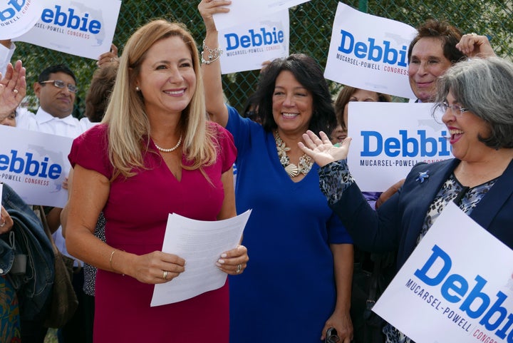 Surrounded by a small group of family and supporters, Democrat Debbie Mucarsel-Powell, left, announced a year ago she would s