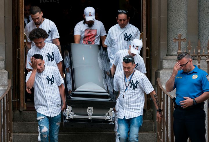 Pallbearers wearing New York Yankee jerseys carry the body of Guzman-Feliz following his funeral service on June 27, 2018.