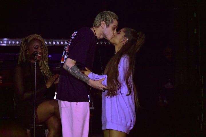Pete Davidson and Ariana Grande share a kiss onstage during "The Sweetener Sessions" in Los Angeles.