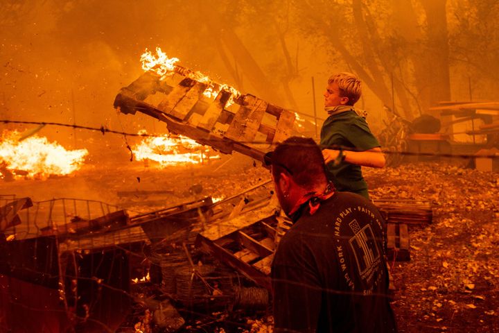 Alex Schenck, 15, fights to save his home as the Ranch fire rages near Clearlake Oaks, California, on, Aug. 4. The state climate assessment says extreme wildfires will occur 50 percent more frequently by the end of the century.