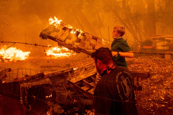 Alex Schenck, 15, fights to save his home as the Ranch fire rages near Clearlake Oaks, California, on, Aug. 4. The state clim