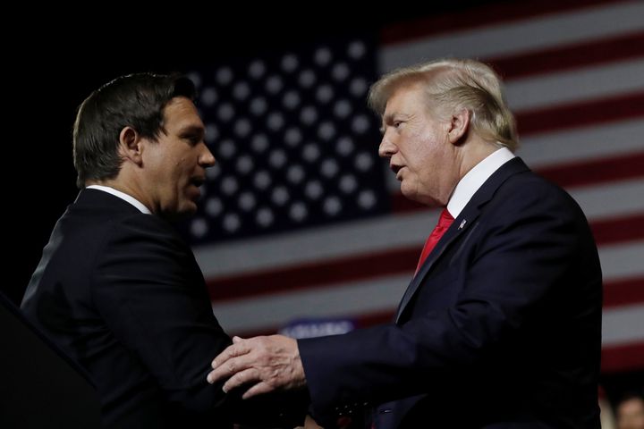 President Donald Trump talks with Ron DeSantis during a Make America Great Again Rally at the Florida State Fairgrounds in Tampa, Florida, on July 31, 2018. 