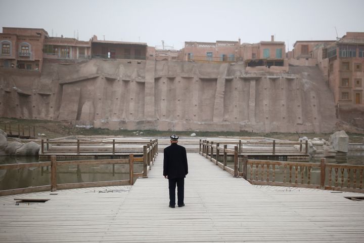 An ethnic Uighur looks at the old town in Kashgar, Xinjiang, in 2017. Per a 2012 Human Rights Watch report, China has razed 80 percent of the traditional Uighur neighborhoods in Kashgar “to make way for a new city likely to be dominated by the Han population.”
