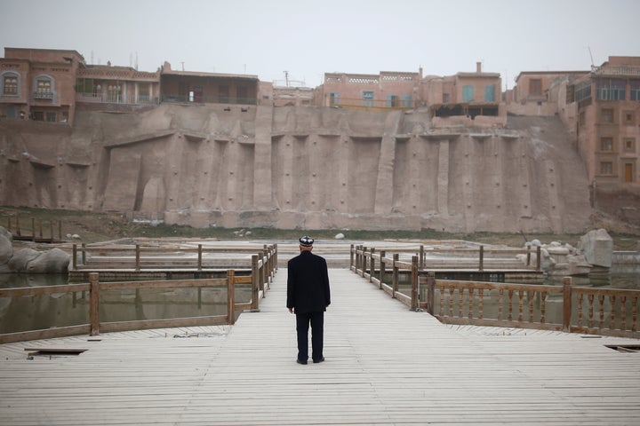 An ethnic Uighur looks at the old town in Kashgar, Xinjiang, in 2017. Per a 2012 Human Rights Watch report, China has ra