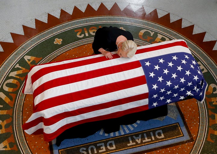 Cindy McCain kisses the casket of her husband, Sen. John McCain, during a memorial service in Phoenix at the state Capitol, Aug. 29.