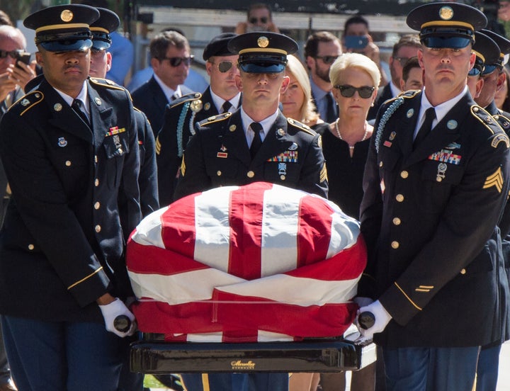 Members of the Arizona National Guard carry John McCain’s casket to the state Capitol Rotunda, followed by Cindy McCain, Aug. 29.