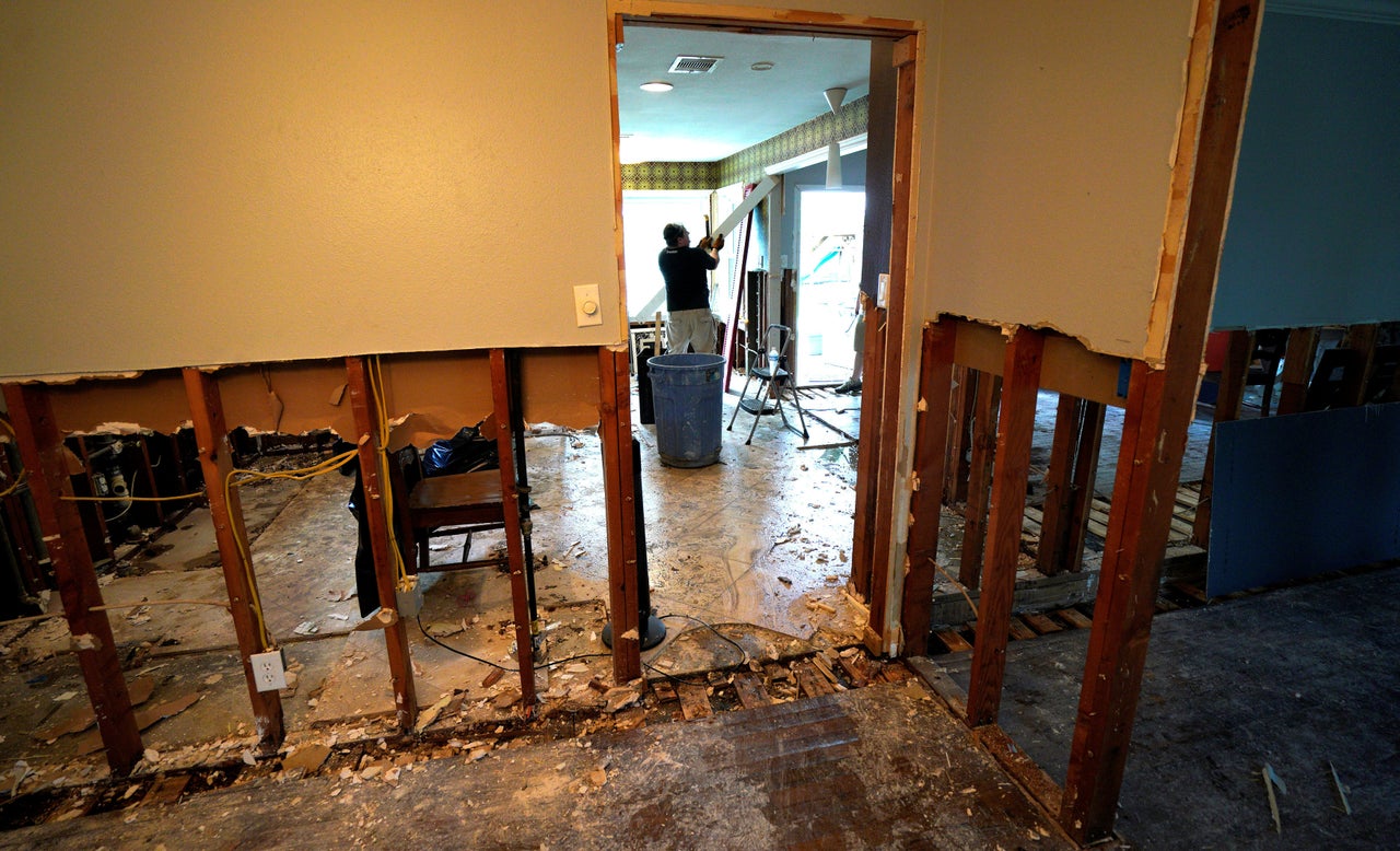 A man tears out flood damage from a home in southwestern Houston on September 2, 2017.