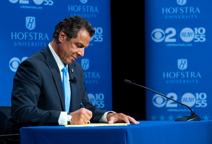 Gov. Andrew Cuomo takes notes during his debate with Democratic rival Cynthia Nixon at Hofstra University on Wednesday.