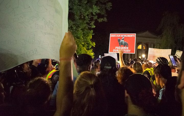 People opposed to a Confederate statue gather around as police escort a group of pro-statue demonstrators through barricades at the University of North Carolina in Chapel Hill on Thursday night.