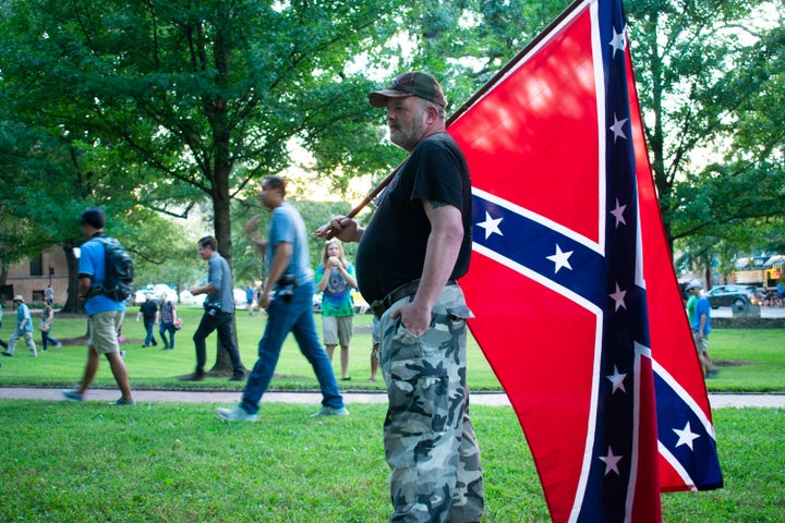 A protester holds a Confederate flag at a Thursday rally on the campus of the University of North Carolina, Chapel Hill.