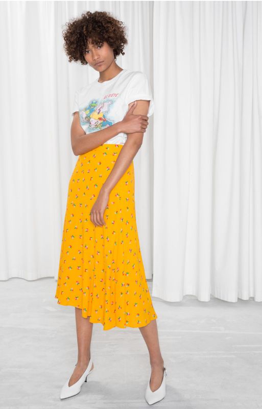 Asymmetrical Floral Midi Skirt, sizes 34-42 available, £34, <a href="https://www.stories.com/en_gbp/clothing/skirts/midi-skirts/product.asymmetrical-floral-midi-skirt-yellow.0623147001.html?gclid=EAIaIQobChMIm5LOuYaX3QIVy7vtCh35VARSEAQYBSABEgJy2vD_BwE" target="_blank" rel="noopener noreferrer">& Other Stories</a>.
