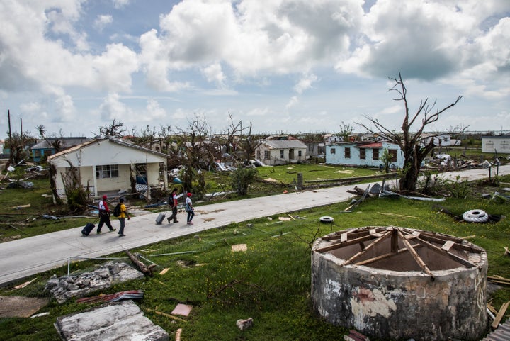 People survey damage on Barbuda, Sept. 24, 2017, in the aftermath of Hurricane Irma.