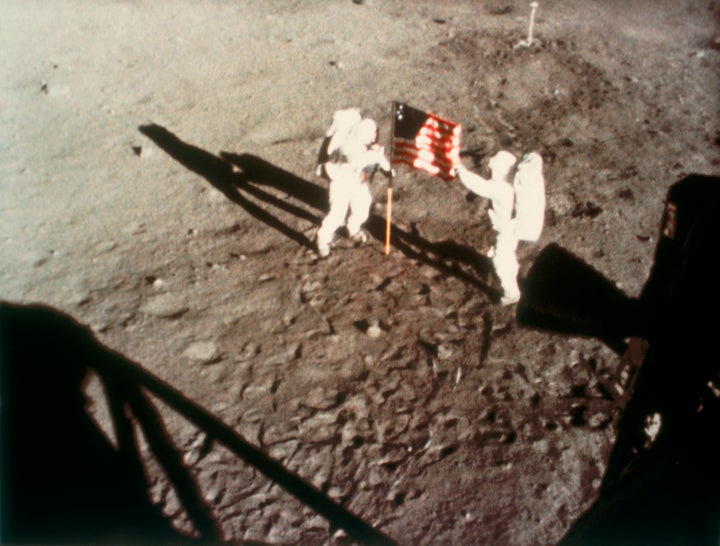 Astronauts Neil Armstrong and Edwin "Buzz" Aldrin plant the American flag on Earth's moon on July 20, 1969.