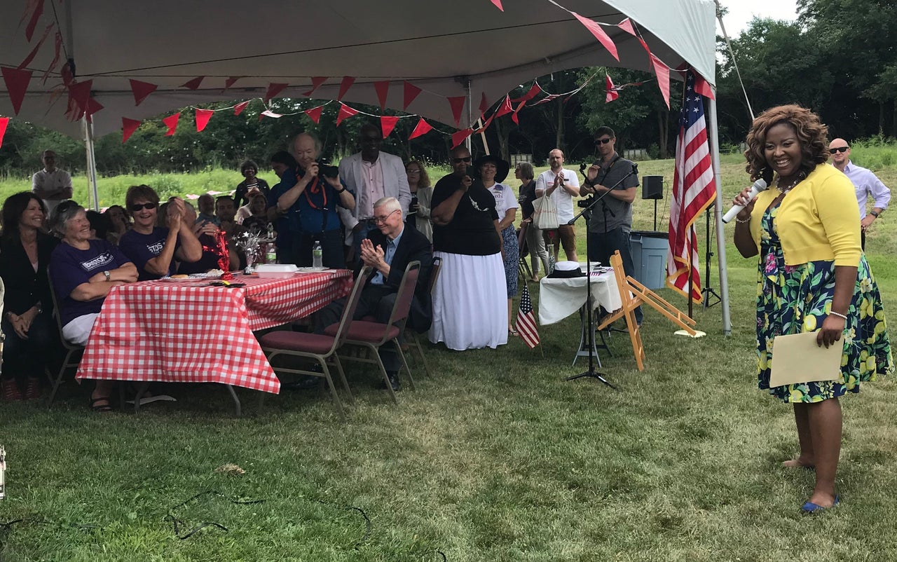 Nikita Richards talks to supporters at her campaign event. Rep. Cheri Bustos (D-Ill.) is sitting upfront, proud of her Build the Bench graduate.