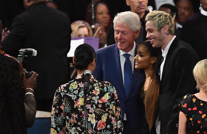 Former President Bill Clinton takes a picture with Grande and her fiancée, Pete Davidson, before Franklin's funeral.