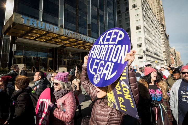 The second annual Women's March passes in front of Trump International Hotel and Tower on Jan. 20, 2018.