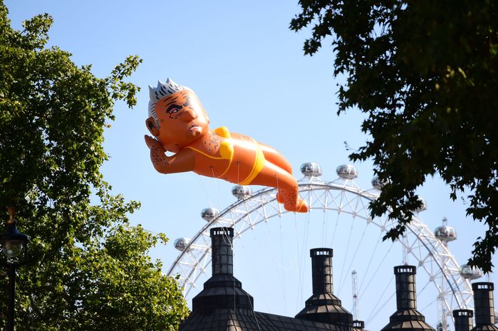 An inflated blimp of London mayor Sadiq Khan depicted in a bikini flies over Parliament Square