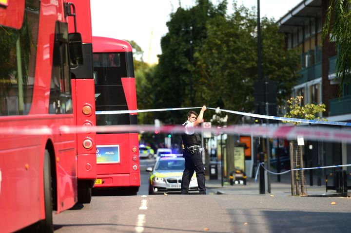 A police officer cordons off the area on the Caledonian Road in Islington, north London.