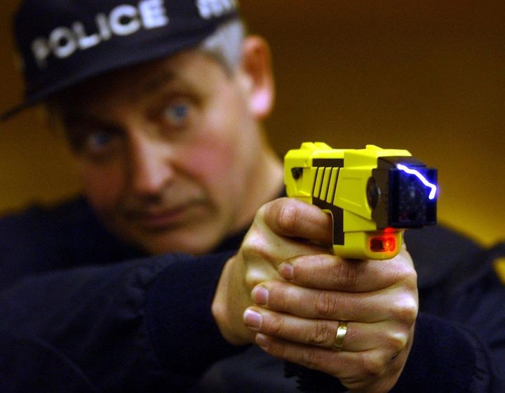A policeman demonstrates how a taser is used at the firearms range of Northamptonshire Police (stock image)