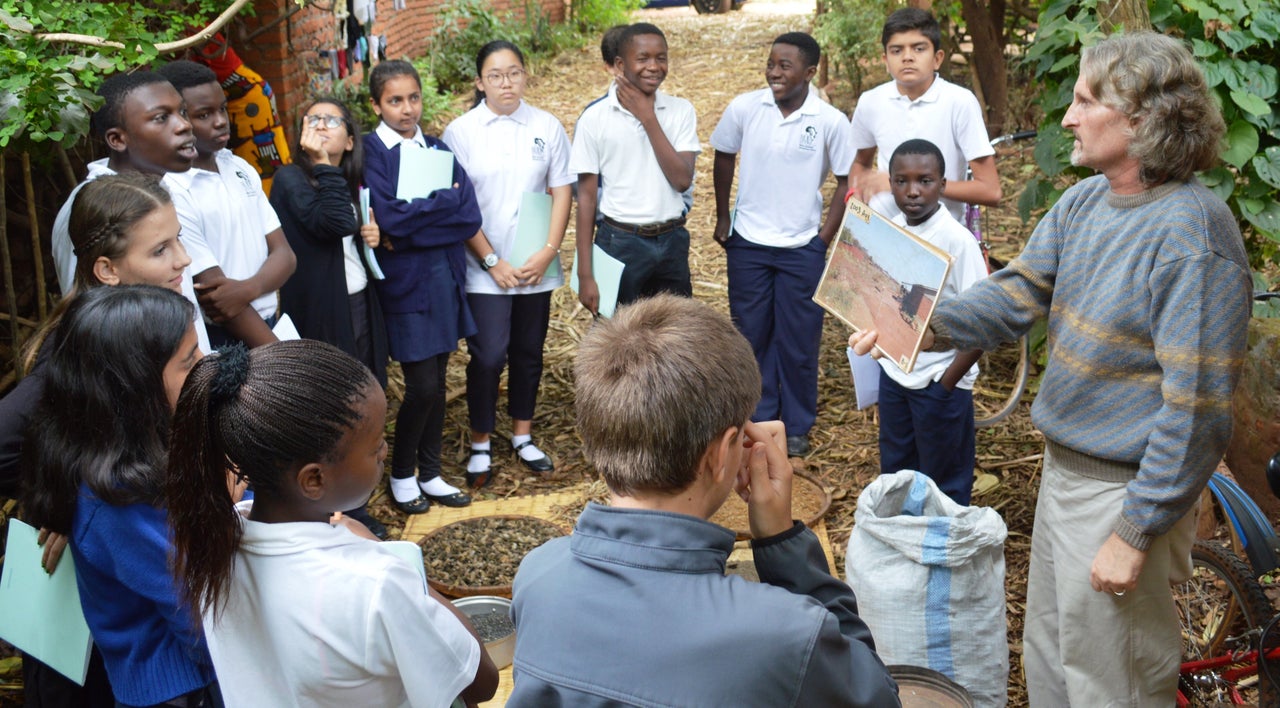 Kristof Nordin teaching a group of international school students about permaculture practices.