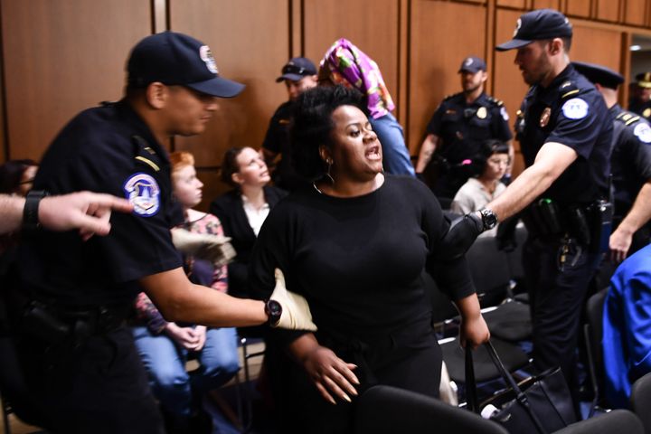 A protester is carried out during Brett Kavanaugh's confirmation hearing.