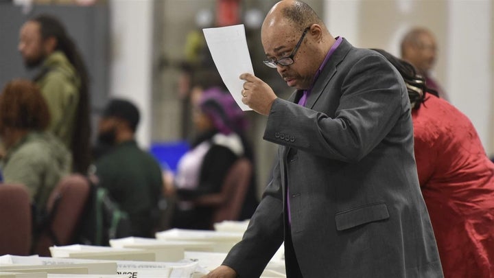 Workers recount the votes cast in the Atlanta mayoral election runoff in Fulton County, Georgia, in 2017. Officials that year tried to eliminate some polling places in majority-black neighborhoods. 