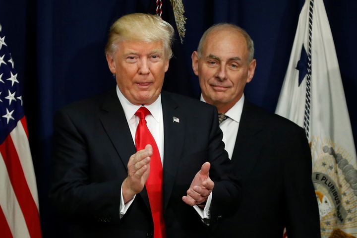 Donald Trump applauds after a ceremonial swearing-in for then US Homeland Security Secretary John F Kelly.