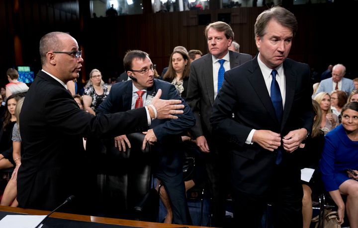 White House counsel Don McGahn (second from right) watches as Fred Guttenberg (left), the father of Jamie Guttenberg, attempts to shake hands with Brett Kavanaugh.