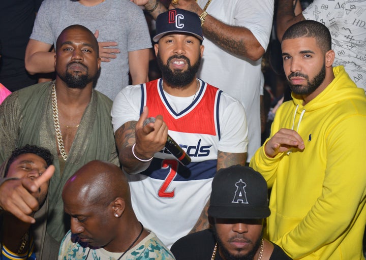 Kanye West and Drake pose together in 2015, albeit separated by industry executive Kenny Burns.