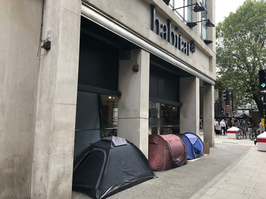 Three homeless men pitch tents outside Habitat furniture shop in Tottenham Court Road