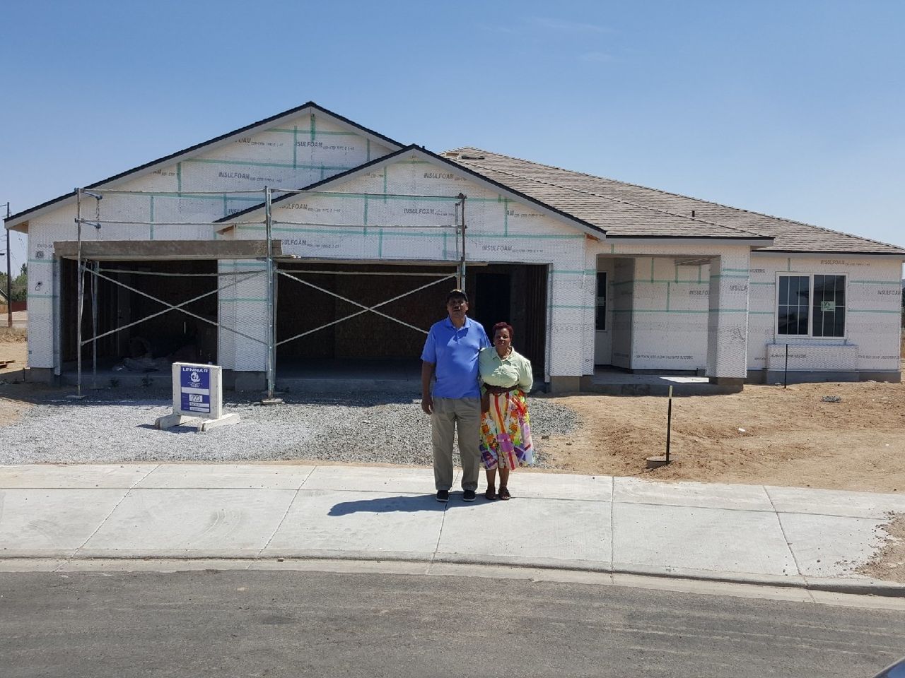 Marion and Lloid Heim stand in front of their new house in Reno, mid-construction -- Aug. 2018