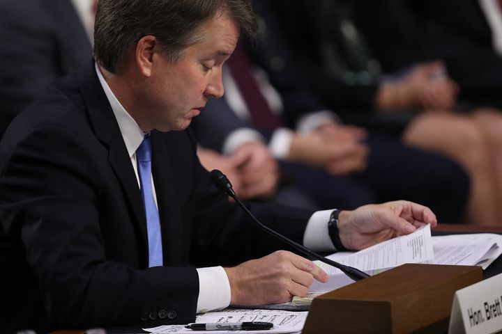 Judge Brett Kavanaugh reads from an email sent to him when working at the White House while answering questions from Sen. Patrick Leahy.