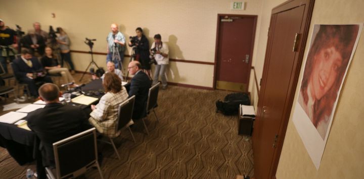 A photo of McKenna Denson when was a 21-year-old missionary is taped to the wall during an April 5 press conference in Salt Lake City.