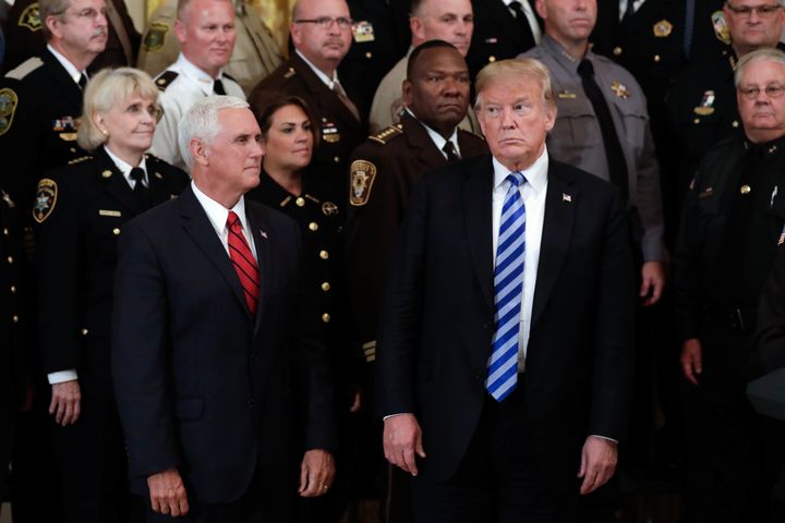 President Donald Trump and Vice President Mike Pence meet with sheriffs from across the country at the White House on Wednesday. At the meeting, Trump challenged the inner-circle "resistance" described by an anonymous op-ed writer.