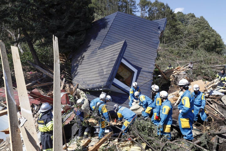 Rescue workers search the rubble for survivors after an earthquake triggered a landslide in Atsuma town, Hokkaido, Japan on Thursday.