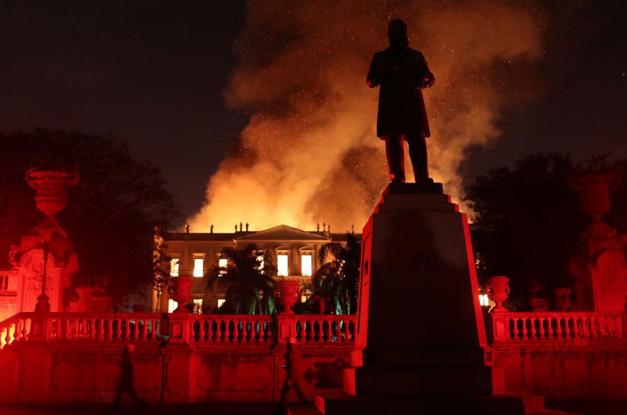 Flames spread behind the Statue of D Pedro II at the Quinta da Boa Vista National Museum