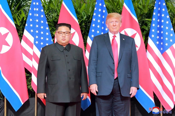 President Donald Trump and North Korean leader Kim Jong Un pose at the Capella Hotel on Sentosa island in Singapore in this picture released on June 12, 2018.