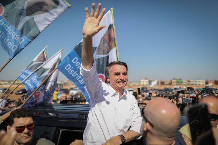 Jair Bolsonaro waves to supports during a campaign rally on September 5