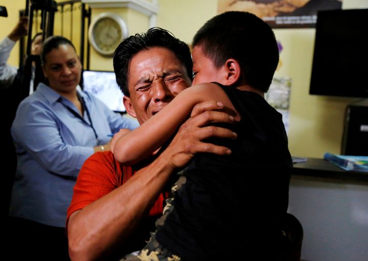 Gilberto Calmo hugs his son Franklin Noe Calmo, who was sent back from detention on Tuesday, after they were separated at the U.S. border, in Guatemala City, Guatemala August 7, 2018.