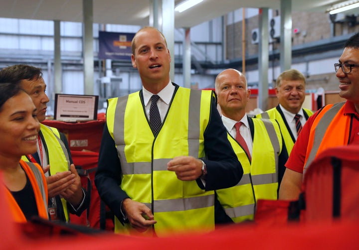 Prince William talks to Royal Mail sorting office workers during a visit to the Royal Mail International Distribution Centre on Sept. 6 in Slough, England.