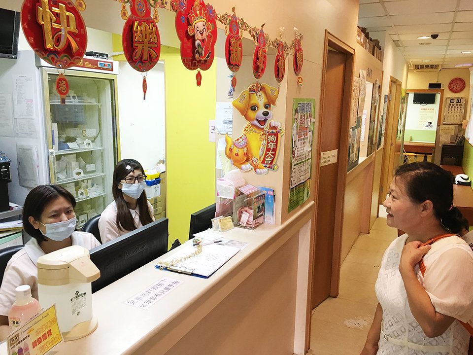 Sofie Ho, pediatrician, speaks with two assistants at her clinic in northwest Taipei. She thinks her country's system works well, but worries about the growing strain on physicians.